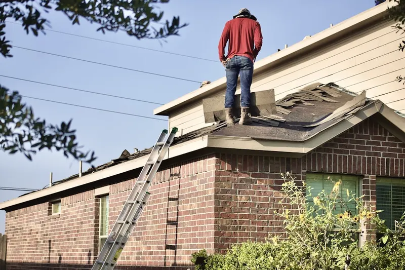 Professional roofer working on a residential roof in Alta